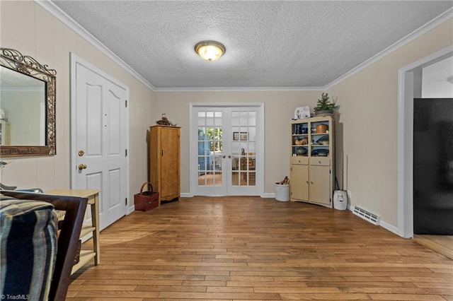 1805 Guilford College Rd, Jamestown, NC 27282 - foyer featuring hardwood / wood-style flooring, ornamental molding, french doors, and a textured ceiling