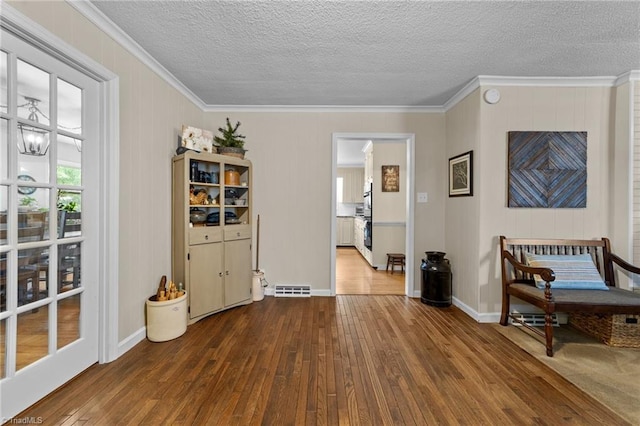 1805 Guilford College Rd, Jamestown, NC 27282 - living area with dark wood-style flooring, crown molding, a textured ceiling, and baseboards