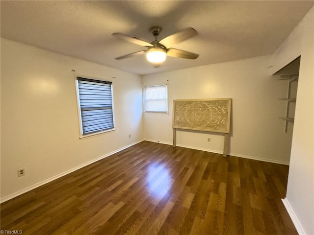 spare room with dark hardwood / wood-style floors and ceiling fan