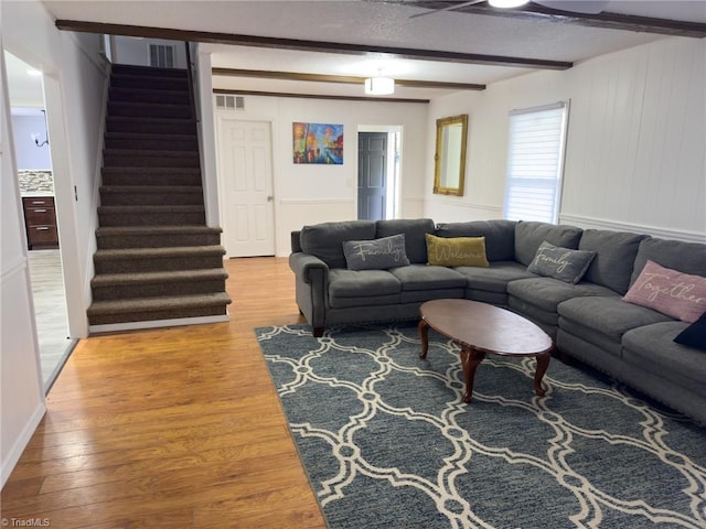 living room featuring hardwood / wood-style floors and beam ceiling