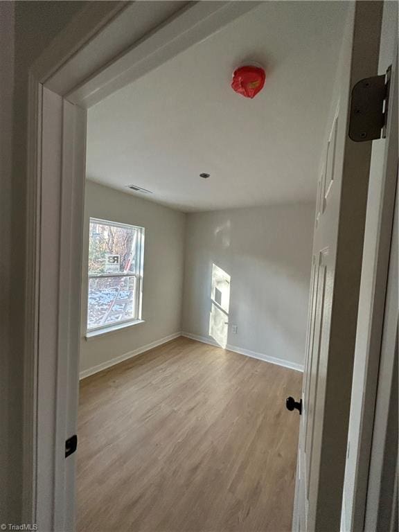 spare room with light hardwood / wood-style floors