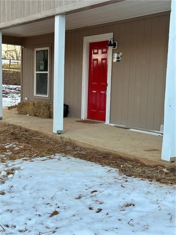 view of snow covered property entrance