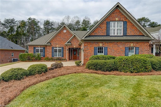 view of front of home featuring central AC and a front lawn