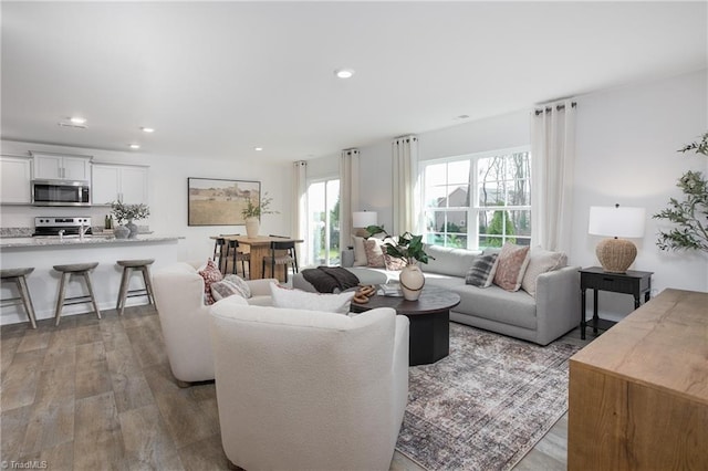 living area with recessed lighting and wood finished floors