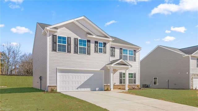 view of front of property featuring driveway, an attached garage, and a front yard