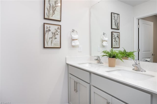 bathroom featuring a sink and double vanity