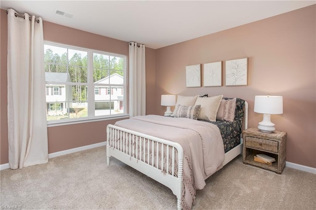 bedroom featuring light carpet, baseboards, and visible vents