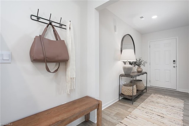 entryway with recessed lighting, visible vents, baseboards, and wood finished floors