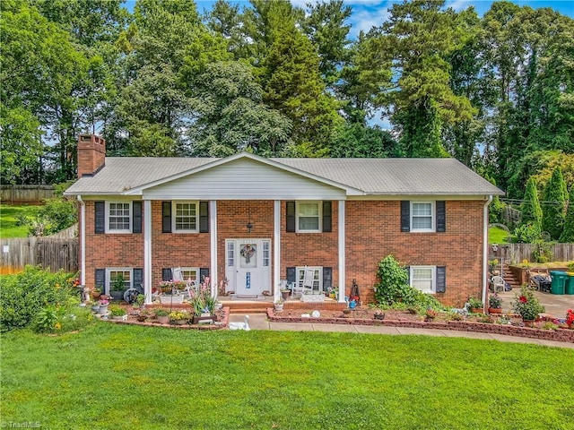 6115 Winview Heights St, Clemmons, NC 27012 - raised ranch featuring brick siding, a chimney, and covered porch