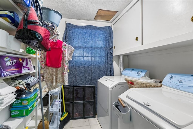 6115 Winview Heights St, Clemmons, NC 27012 - washroom featuring cabinet space, independent washer and dryer, light tile patterned floors, and a textured ceiling