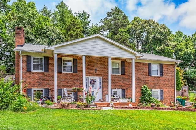 6115 Winview Heights St, Clemmons, NC 27012 - bi-level home with brick siding, a chimney, a front yard, and covered porch