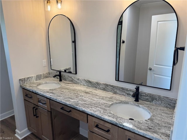 2322 Fernwood Dr, Greensboro, NC 27408 - full bath with double vanity, crown molding, wood finished floors, and baseboards
