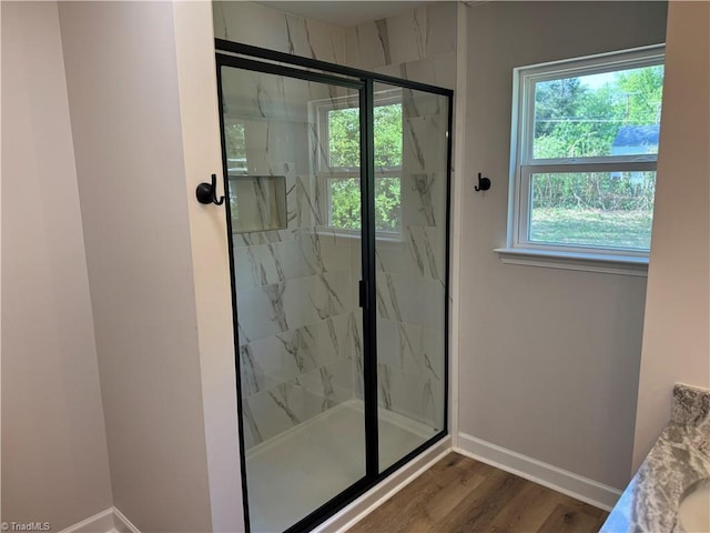 2322 Fernwood Dr, Greensboro, NC 27408 - full bath with a marble finish shower, baseboards, and wood finished floors