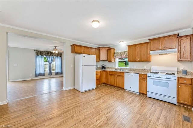 78 Arnies Ln, Sparta, NC 28675 - kitchen with white appliances, under cabinet range hood, a sink, brown cabinetry, and ornamental molding