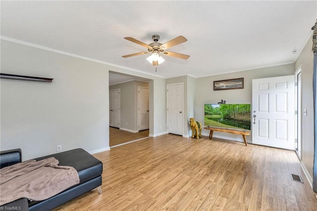 78 Arnies Ln, Sparta, NC 28675 - living room featuring ceiling fan, baseboards, light wood finished floors, ornamental molding, and plenty of natural light