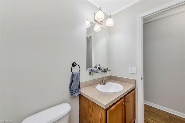 78 Arnies Ln, Sparta, NC 28675 - half bathroom with vanity, toilet, wood finished floors, ornamental molding, and baseboards