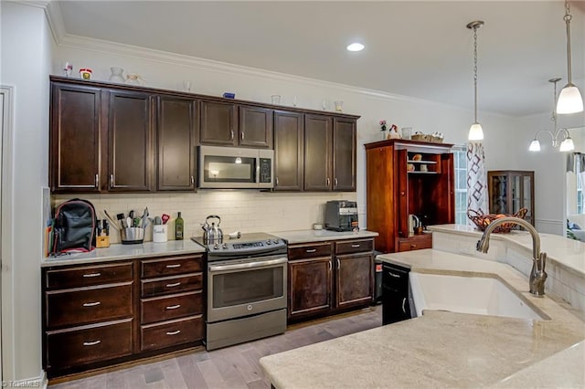 4116 Branch Point Ct, Pfafftown, NC 27040 - kitchen featuring appliances with stainless steel finishes, a sink, light countertops, backsplash, and ornamental molding
