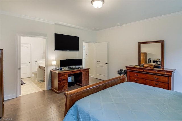 4116 Branch Point Ct, Pfafftown, NC 27040 - bedroom featuring wood finished floors, ornamental molding, connected bathroom, a desk, and baseboards