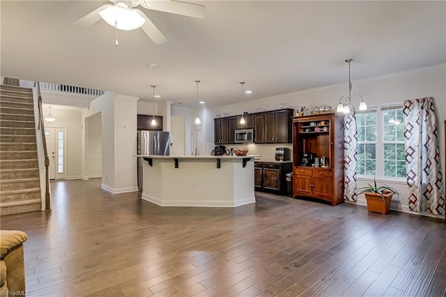 4116 Branch Point Ct, Pfafftown, NC 27040 - kitchen featuring stainless steel appliances, a breakfast bar area, dark wood-style flooring, ceiling fan, and crown molding