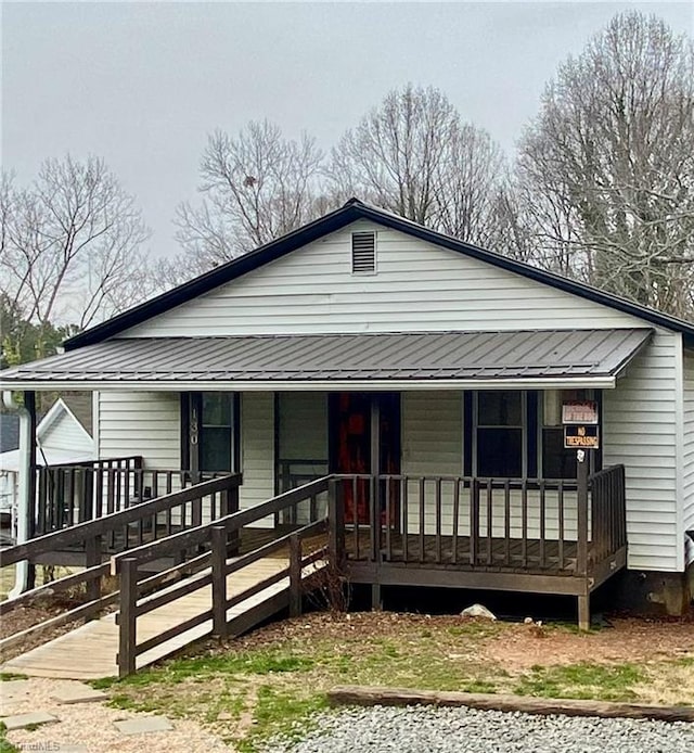 view of front of home featuring a porch and metal roof