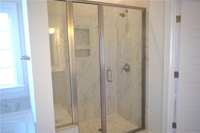 bathroom with a shower with shower door