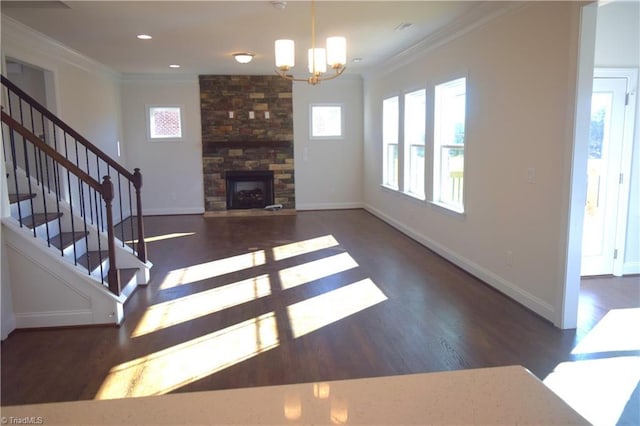 living room featuring a fireplace, dark hardwood / wood-style flooring, crown molding, and a notable chandelier