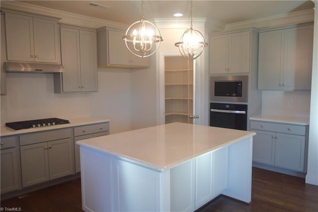 kitchen with built in microwave, wall oven, a chandelier, decorative light fixtures, and gray cabinets