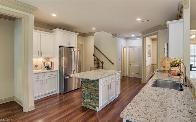 kitchen featuring a center island, dark wood finished floors, a sink, white cabinets, and high end fridge