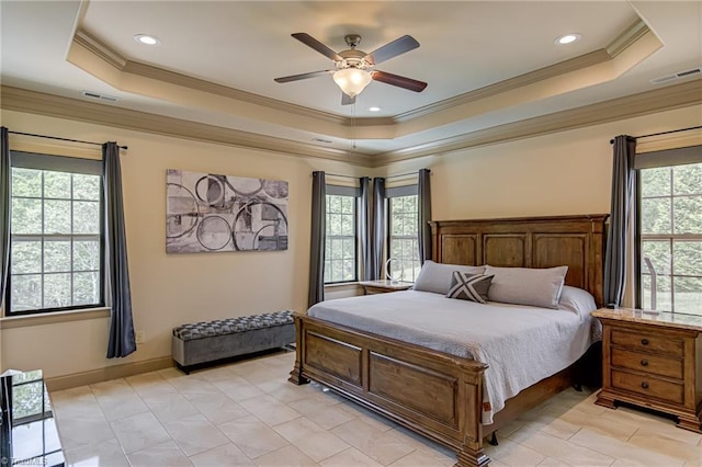 bedroom featuring a tray ceiling, visible vents, and ornamental molding