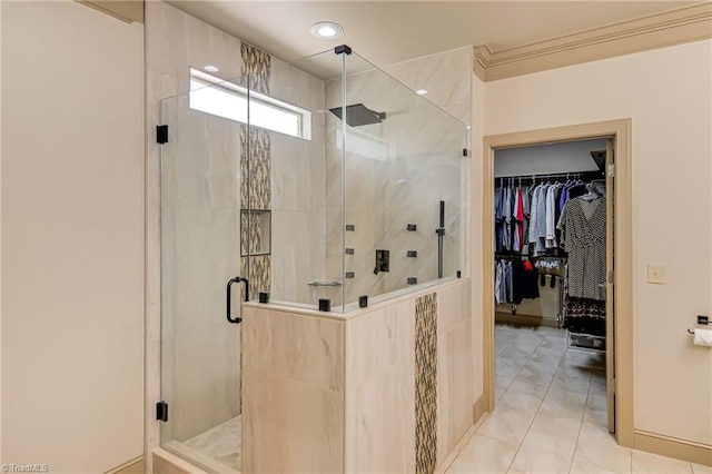 full bath featuring crown molding, a spacious closet, and a stall shower