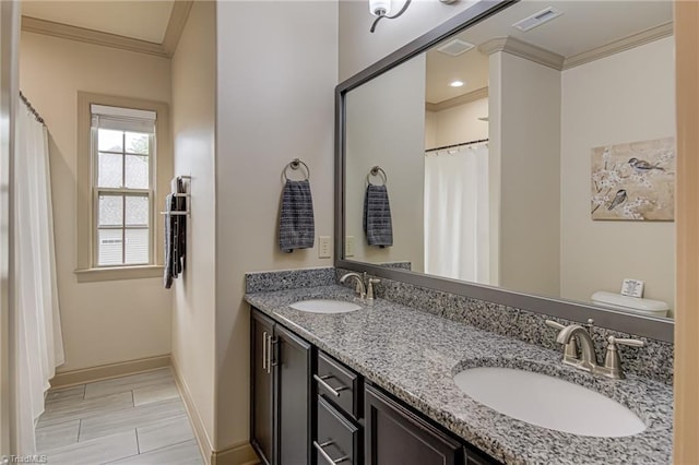 full bathroom featuring visible vents, ornamental molding, and a sink