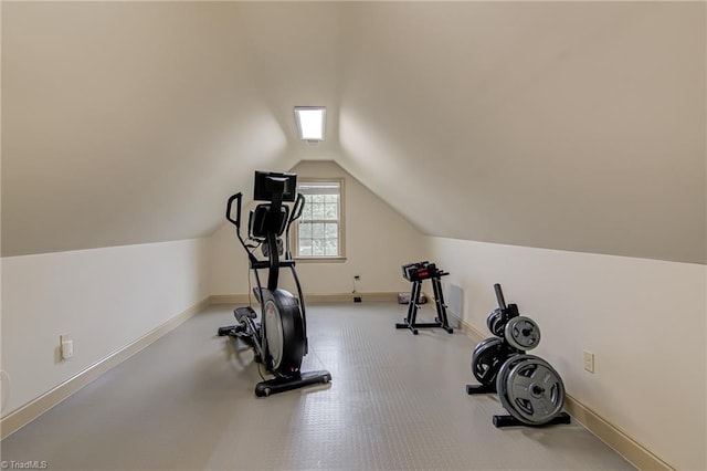 exercise area featuring baseboards and vaulted ceiling
