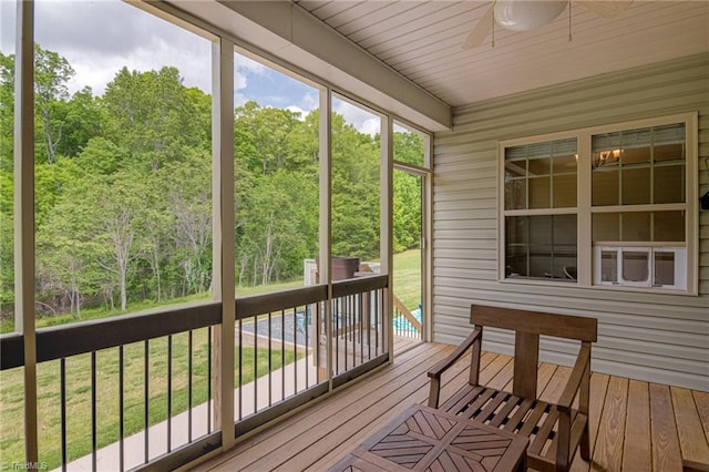 unfurnished sunroom with ceiling fan