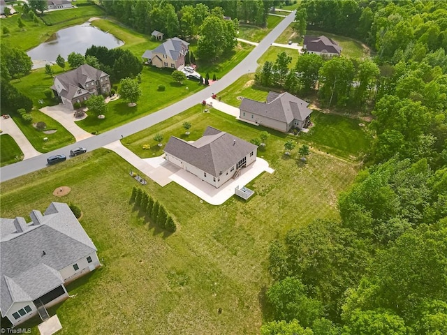 drone / aerial view featuring a water view and a residential view