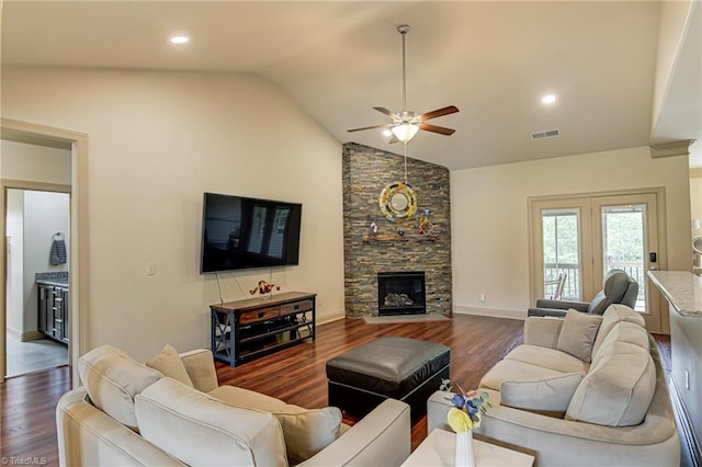living room with dark wood-style flooring, a fireplace, a ceiling fan, baseboards, and visible vents