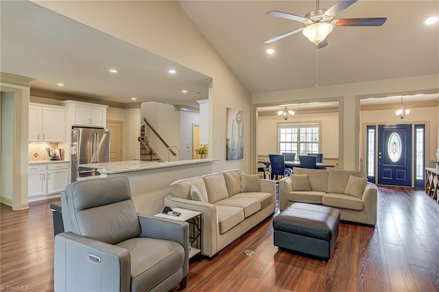 living room with recessed lighting, ceiling fan with notable chandelier, vaulted ceiling, and stairway