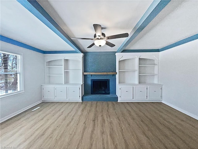 unfurnished living room with ceiling fan, a fireplace, light wood-style flooring, and baseboards