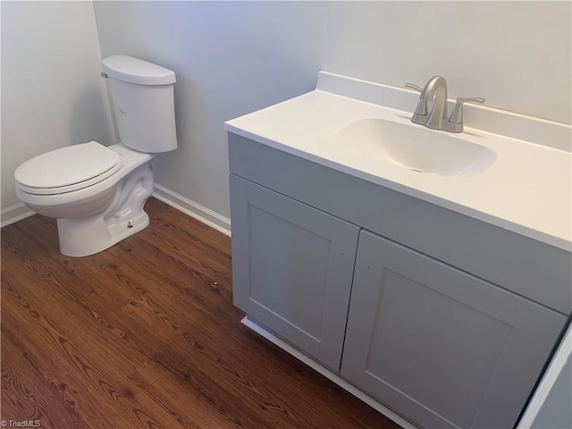 744 Caleb St, Eden, NC 27288 - bathroom featuring baseboards, vanity, toilet, and wood finished floors