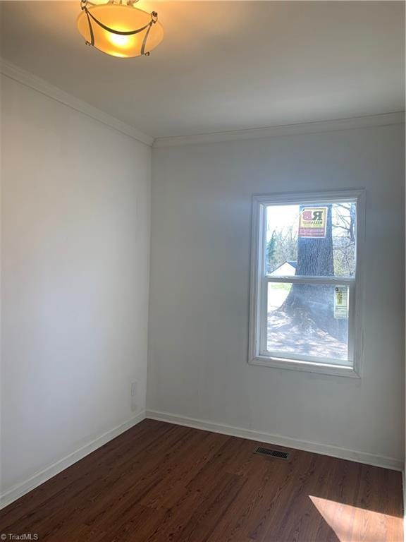 744 Caleb St, Eden, NC 27288 - empty room with crown molding, dark wood-style floors, and baseboards