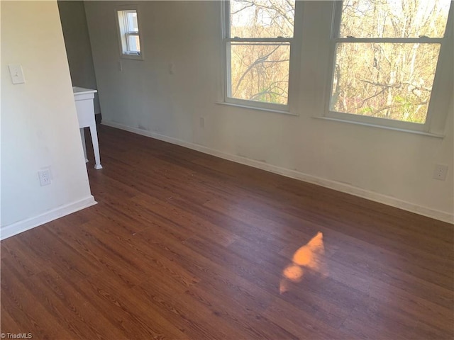 744 Caleb St, Eden, NC 27288 - unfurnished room with baseboards, dark wood finished floors, and healthy amount of natural light