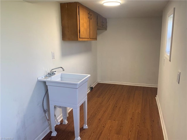 744 Caleb St, Eden, NC 27288 - laundry room featuring dark wood-style flooring, baseboards, and cabinet space
