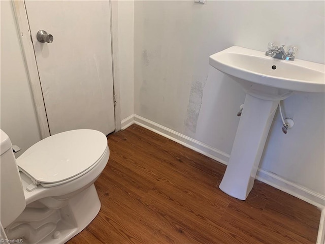 744 Caleb St, Eden, NC 27288 - bathroom featuring wood finished floors, toilet, and a sink
