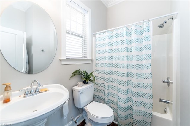 bathroom with ornamental molding, toilet, shower / bathtub combination with curtain, and a sink