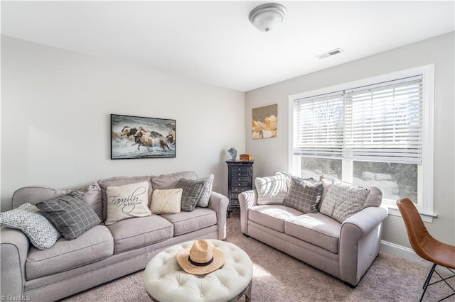 carpeted living room featuring baseboards and visible vents