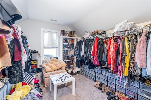 spacious closet featuring lofted ceiling, carpet, and visible vents