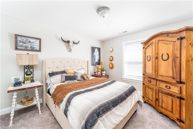 bedroom featuring light carpet, visible vents, and baseboards