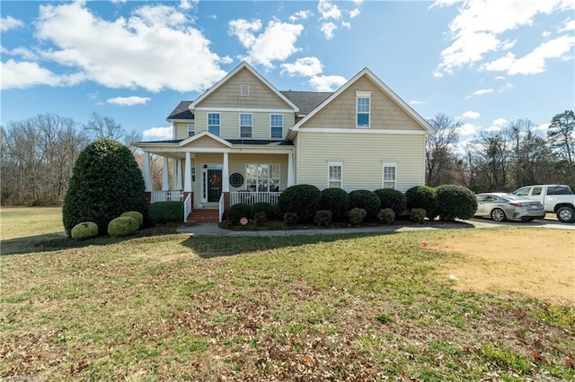 craftsman-style home featuring a front lawn and covered porch