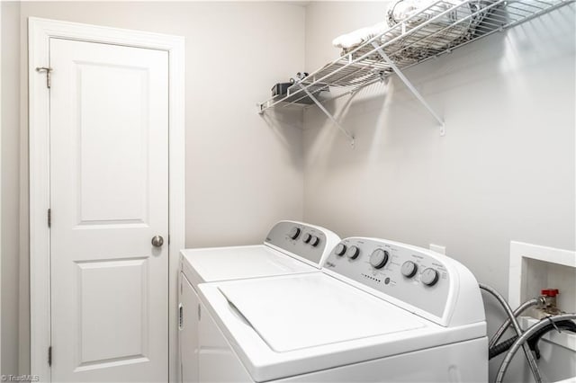 laundry room with laundry area and washing machine and clothes dryer