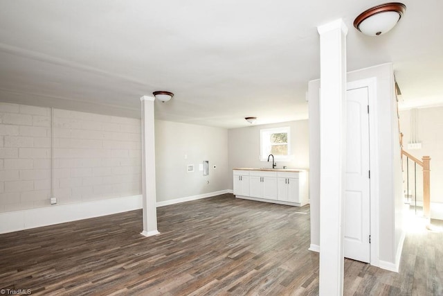 basement with sink and dark hardwood / wood-style flooring