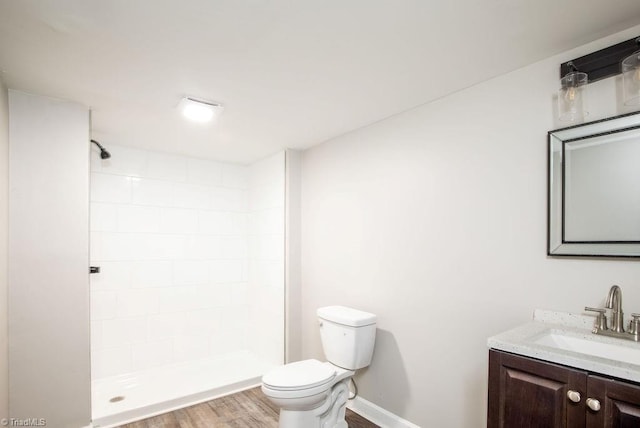 bathroom with vanity, hardwood / wood-style flooring, toilet, and walk in shower